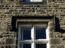 Ornamental dripstone over the window of No. 38 Collegiate Crescent, with carved heads