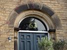 Carved half light over the doorway of No. 63 Clarkegrove Road 