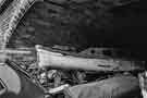 Old boat and rubble beneath a former railway arch, Sheffield Canal Basin (later Victoria Quays)