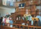 Interior of Woodhouse Trinity Methodist Church (formerly Woodhouse Wesleyan Church) showing minister with children at front of the church by the pulpit