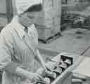 Batchelors Foods Ltd., Sheffield factory: Preparation Department - operating the machine which removes the ends of the carrots is Mrs Irene Roebuck, [Limestone Cottage Lane], Sheffield