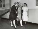 Nurses helping a male patient in plaster to walk with crutches, probably Royal Hospital, West Street Nurses helping a male patient in plaster to walk with crutches, probably Royal Hospital, West Street