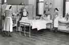 Sister demonstrating use of implements with male patient in bed, Clarke House School of Nursing, Clarke Drive Sister demonstrating use of implements with male patient in bed, Clarke House School of Nursing, Clarke Drive