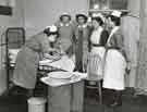 Nurse demonstrating how to clean a baby, Clarke House School of Nursing, Clarke Drive Nurse demonstrating how to clean a baby, Clarke House School of Nursing, Clarke Drive