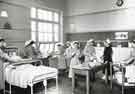 Students being instructed in how to look after patients in bed showing trolleys with various liquid containers and bowls, Clarke House School of Nursing, Clarke Drive Students being instructed in how to look after patients in bed showing trolleys with various liquid containers and bowls, Clarke House School of Nursing, Clarke Drive