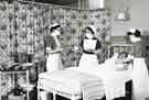 Students being instructed in how to look after patients in bed showing trolleys with various liquid containers and bowls, Clarke House School of Nursing, Clarke Drive Students being instructed in how to look after patients in bed showing trolleys with various liquid containers and bowls, Clarke House School of Nursing, Clarke Drive