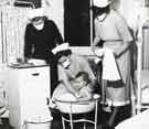 Bathing a baby showing two nurses under tuition, Clarke House School of Nursing, Clarke Drive Bathing a baby showing two nurses under tuition, Clarke House School of Nursing, Clarke Drive