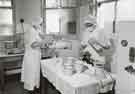 Nurses with masks measuring milk for feeding bottles, Clarke House School of Nursing, Clarke Drive Nurses with masks measuring milk for feeding bottles, Clarke House School of Nursing, Clarke Drive