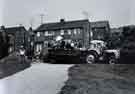 Children on trailer and tractor in unidentified location