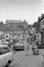 Shops on Abbeydale Road looking towards junction with Sheldon Road showing (back) St. Peter's Church, Machon Bank, mid 1970s