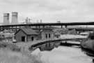 Derelict buildings on the Sheffield and South Yorkshire Navigation at Meadowhall showing the Tinsley Viaduct and (left) Tinsley cooling towers, mid 1970s