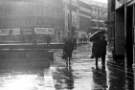 Fargate in the rain showing (centre) Timpsons Shoes, Nos. 2 - 6 Pinstone Street