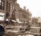 Traffic on Surrey Street looking towards junction with Norfolk Street showing (left) entrance to the Montgomery Hall and No. 35 Mitchell Clement Ltd., hosiers