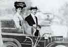 The parents of Mrs A. M. Knowles of Darnall posing behind a car cut out with cloth background The parents of Mrs A. M. Knowles of Darnall posing behind a car cut out with cloth background
