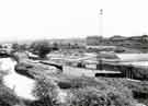 View of the storm drain for the Blackburn Meadows sewage treatment plant where it enters the River Don. British Steel Corporation, Rotherham can be seen in background
