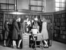 View: s46599 Miss Charlesworth with a group of girls in the Central Library during school instruction