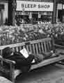 Man sleeping on a bench outside The Sleep Shop, bedding retailers, No.9 Fitzalan Square Man sleeping on a bench outside The Sleep Shop, bedding retailers, No.9 Fitzalan Square