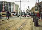 View from Commercial Street of Supertrams at Castle Square Supertram stop showing (left) T. J. Hughes, department store, High Street