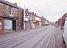 Supertram on Holme Lane showing (left) No. 118 P. L. E., electrical engineers and contractors and (centre) Nos. 108 - 110 Crocatile Discount Centre