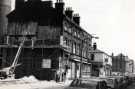 View: t11937 Demolition of shops on Division Street showing (centre) No. 102 the Royal Hospital Hearing Aid Centre and (right) No. 94 Prince of Wales Hotel (latterly the Frog and Parrot public house)