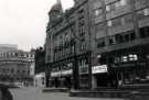 Fargate showing (l. to r.) Nos. 62 - 64 Joan Barrie Ltd., ladies fashions; No. 58 Burnley Building Society; Nos. 54 - 56 (first floor) La Coupe, unisex hairdressers and Nos. 54 -56 The Golden Egg Restaurant