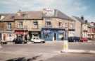 Shops on Common Side showing (l. to r.) No. 15 Janettes, barbers; No. 17 Flower Bok and No. 19 WRD Building Services and (right) Sydney Road