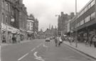 View: u11439 Shops on Pinstone Street looking towards (back centre) the Town Hall showing (left) Sewing and Knitting Centre; Evolution; Hearts; Extras and Abbey National Building Society