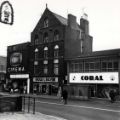 View: u11607 Fitzalan Square showing (l. to r.) Classic Cinema, No. 7 Cheecklyn Ltd. (former premises of the Bell Hotel), ladies and gents outfitters and No. 9 Coral, bookmakers