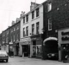 Shops on Norfolk Row showing (r. to l.) No. 2 Georgian Goldsmiths Ltd., St. Maries book shop, GT Sports, Golf Scene and Mark Jenkinson and Son, estate agents