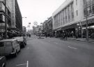 Shops on The Moor at Christmas showing (r.to l.) No. 29  Montague Burton Ltd., tailors; Nos. 15 - 19 F. W. Woolworth and Co. Ltd., department store and (left) Debenhams, department store