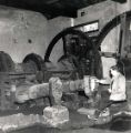 View: u11785 Mr E. A. Walker with the water driven tilt hammers, Abbeydale Works, former premises of W. Tyzack, Sons and Turner Ltd., manufacturers of files, saws, scythes etc., prior to restoration and becoming Abbeydale Industrial Hamlet Museum in 1970