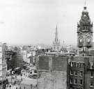 View of (left) Barkers Pool, (centre left) Fargate, (centre) side view of Town Hall Chambers and (right) Town Hall clock tower and rear of shops and businesses on Pinstone Street