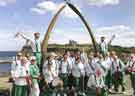 Sheffield City Morris. The whole group under the whalebone arch during the Whitby Folk Week, North Yorkshire