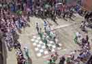 Sheffield City Morris. the team dancing on a chess board, in a court yard off George Street at the Jack in the Green Festival, Hastings, East Sussex