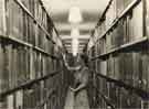 Miss Shepherd shelving books in the Library Stack, Central Library, Surrey Street Miss Shepherd shelving books in the Library Stack, Central Library, Surrey Street