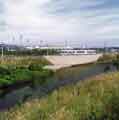 Supertram running alongside the Sheffield and South Yorkshire canal showing (back centre) Don Valley Stadium