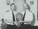 South Yorkshire County Fire Service: Chief Fire Officer H. E. Wright (right) presents a sports award to a firefighter